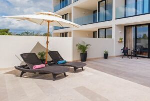 Two sun loungers on the spacious private terrace at Novara 202 vacation rental in Cozumel