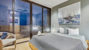 Cozy bedroom with king-size bed at Distrito Centro 602 vacation rental in downtown Cozumel