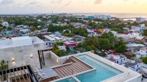 Drone view of the rooftop swimming pool and common area at Distrito Centro in downtown Cozumel