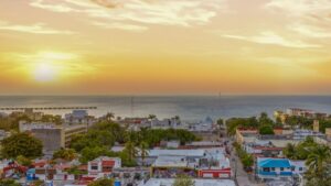 Rooftop common area at Distrito Centro with panoramic views over downtown Cozumel and the Caribbean Sea