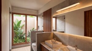 Modern bathroom in Casa Sacbé with double sinks and contemporary finishes, designed for a custom home in Cozumel.